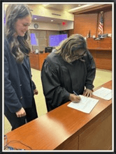 Emmy Whitaker signing in at the courthouse.