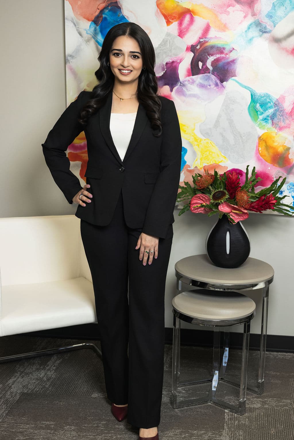 Anushay Khalid standing in a modern office, professionally dressed