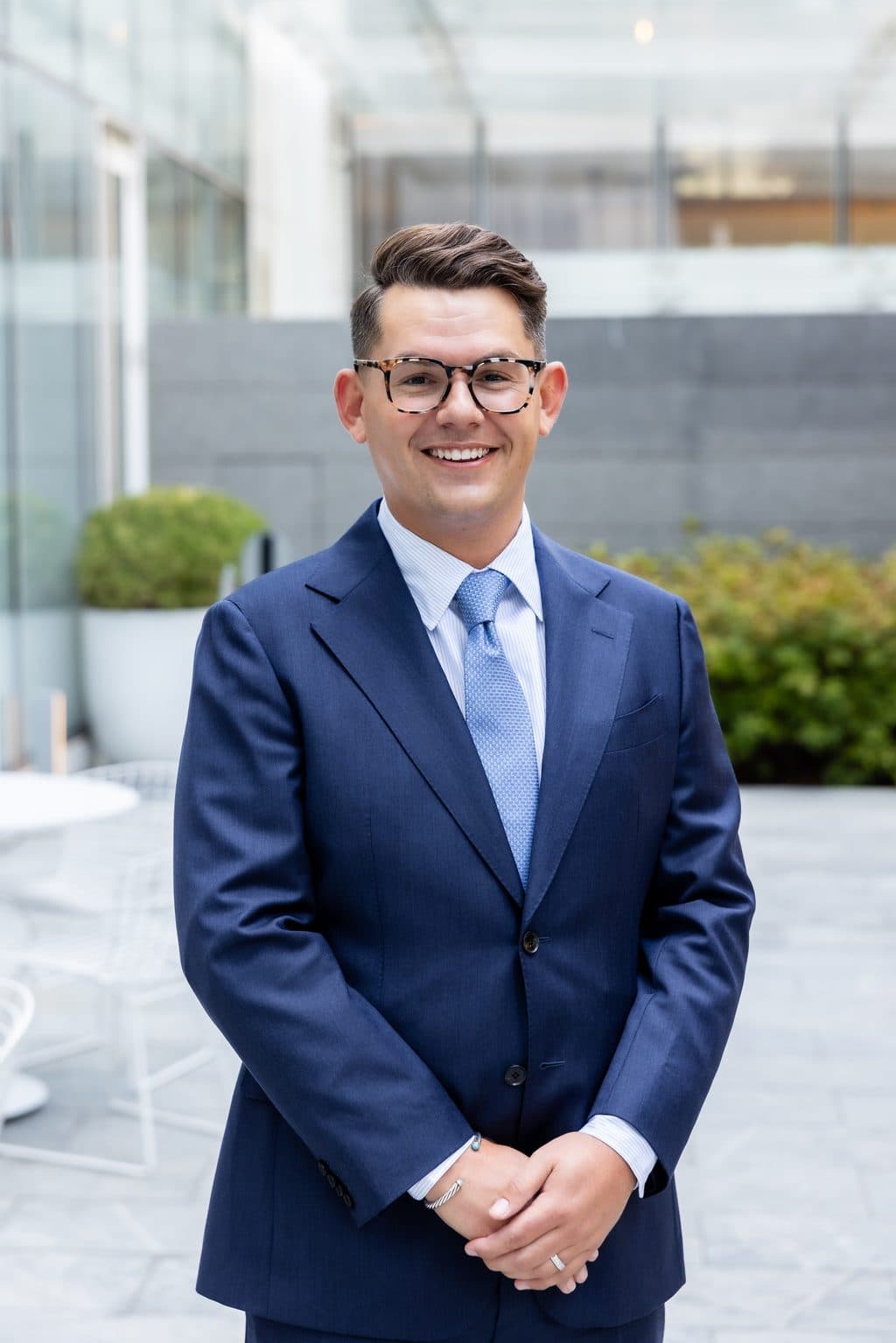 Professional portrait of Joe Otanez, Associate Attorney, in a navy suit