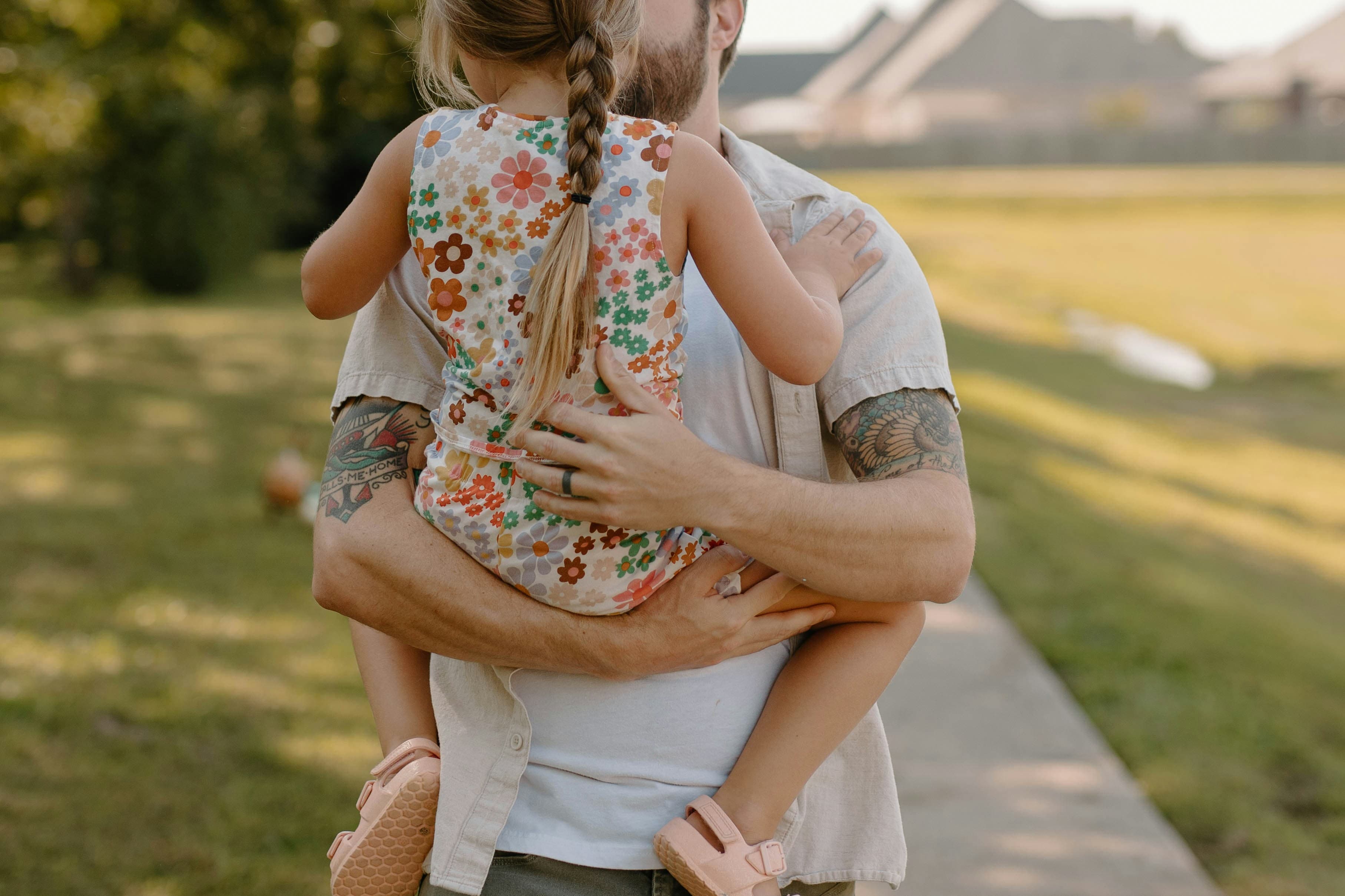 Father carrying his child in a supportive embrace