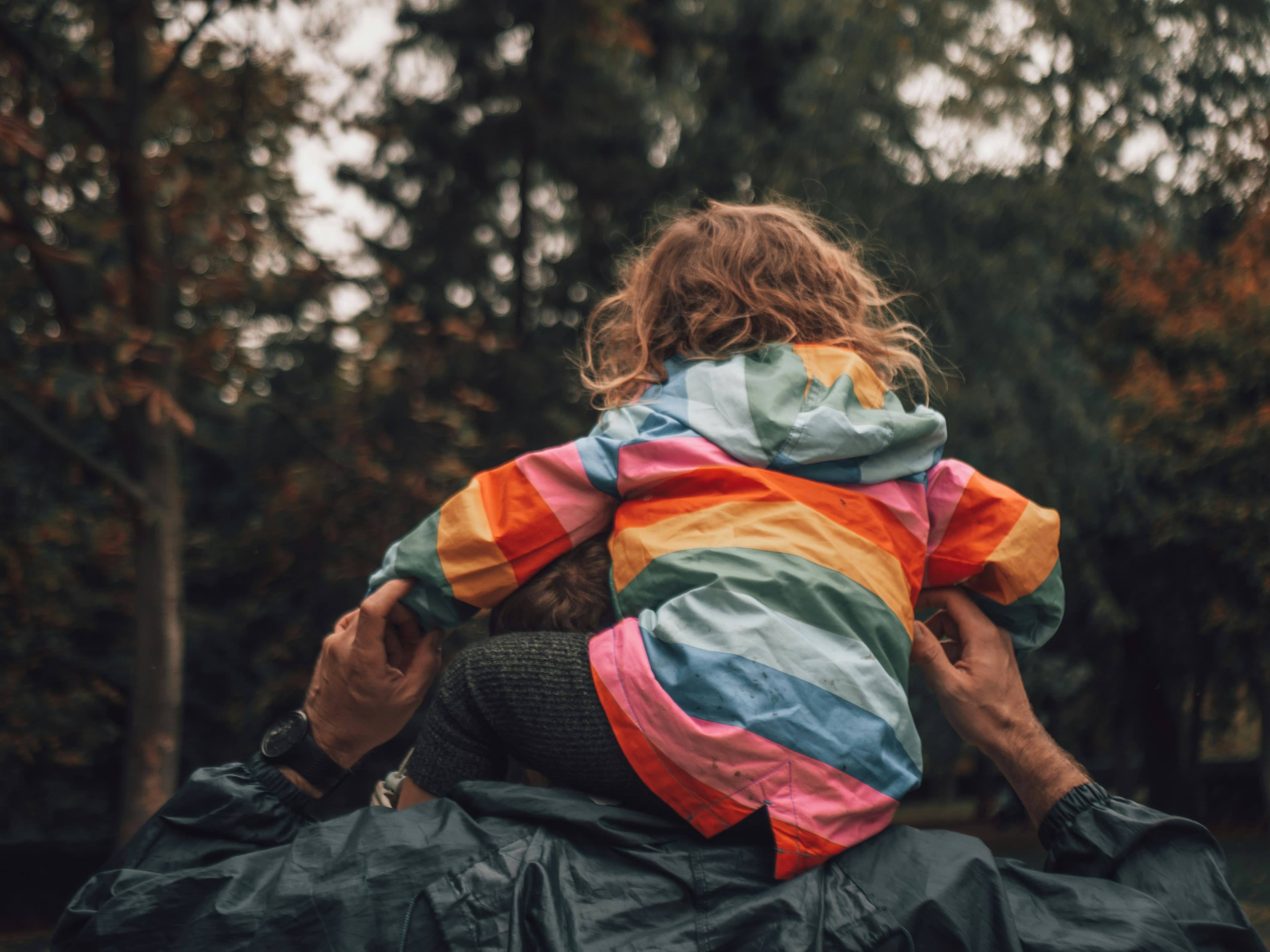 Child in a colorful jacket representing long-term family support
