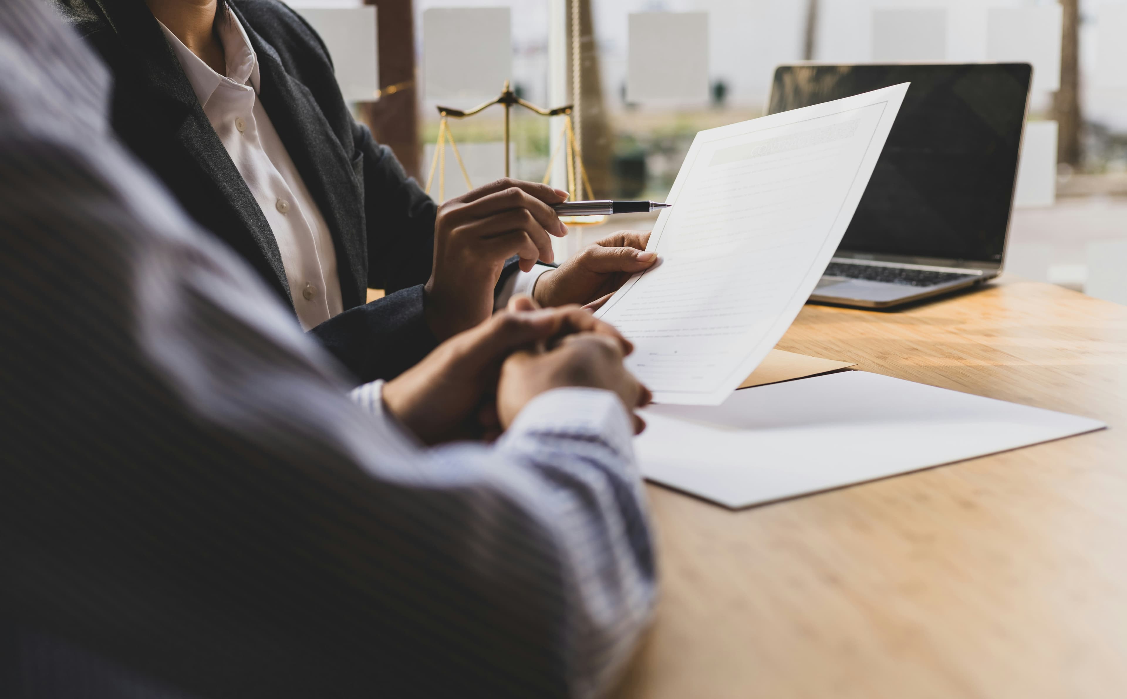Attorney reviewing legal papers with a divorce client