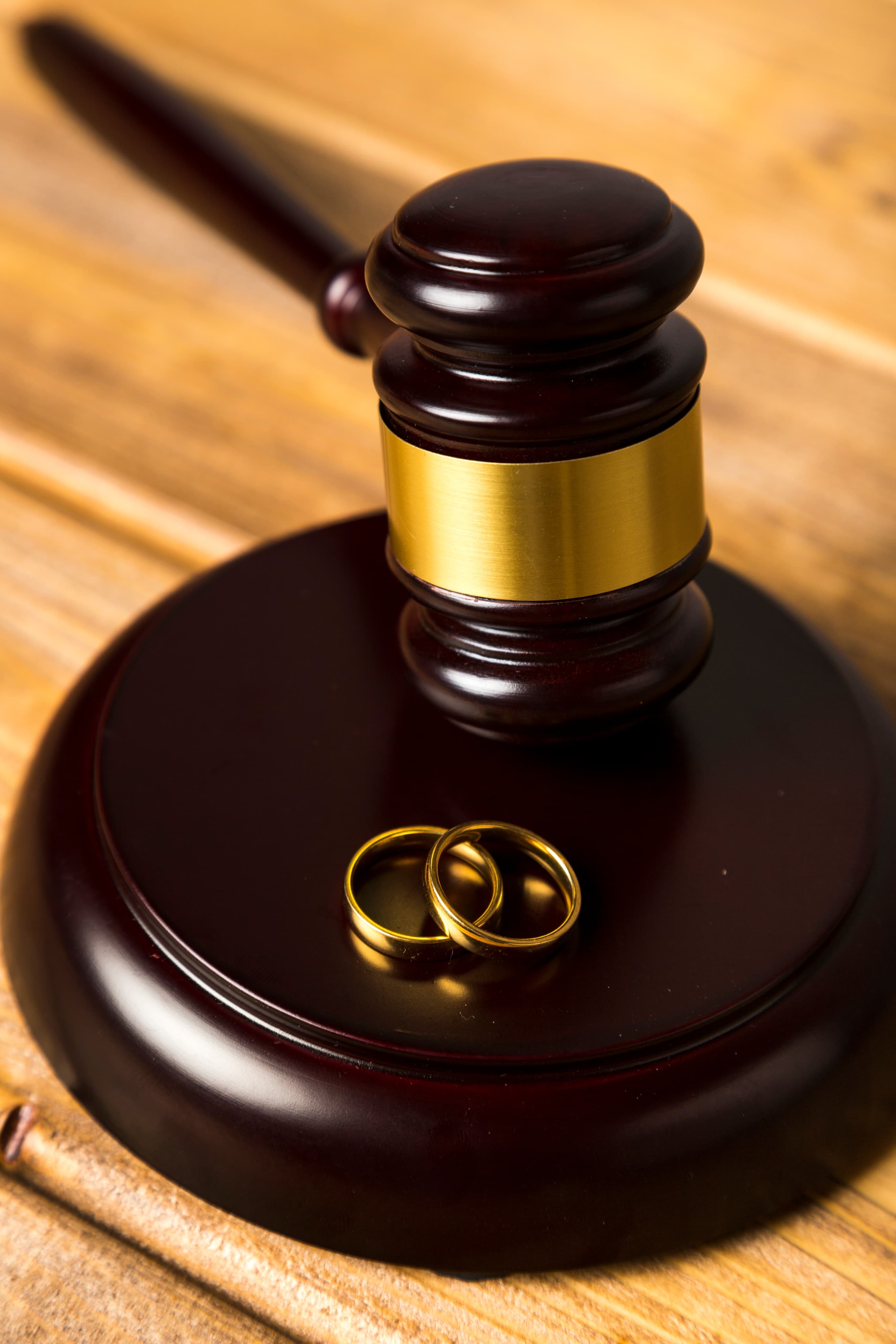 Gavel and wedding rings on legal documents