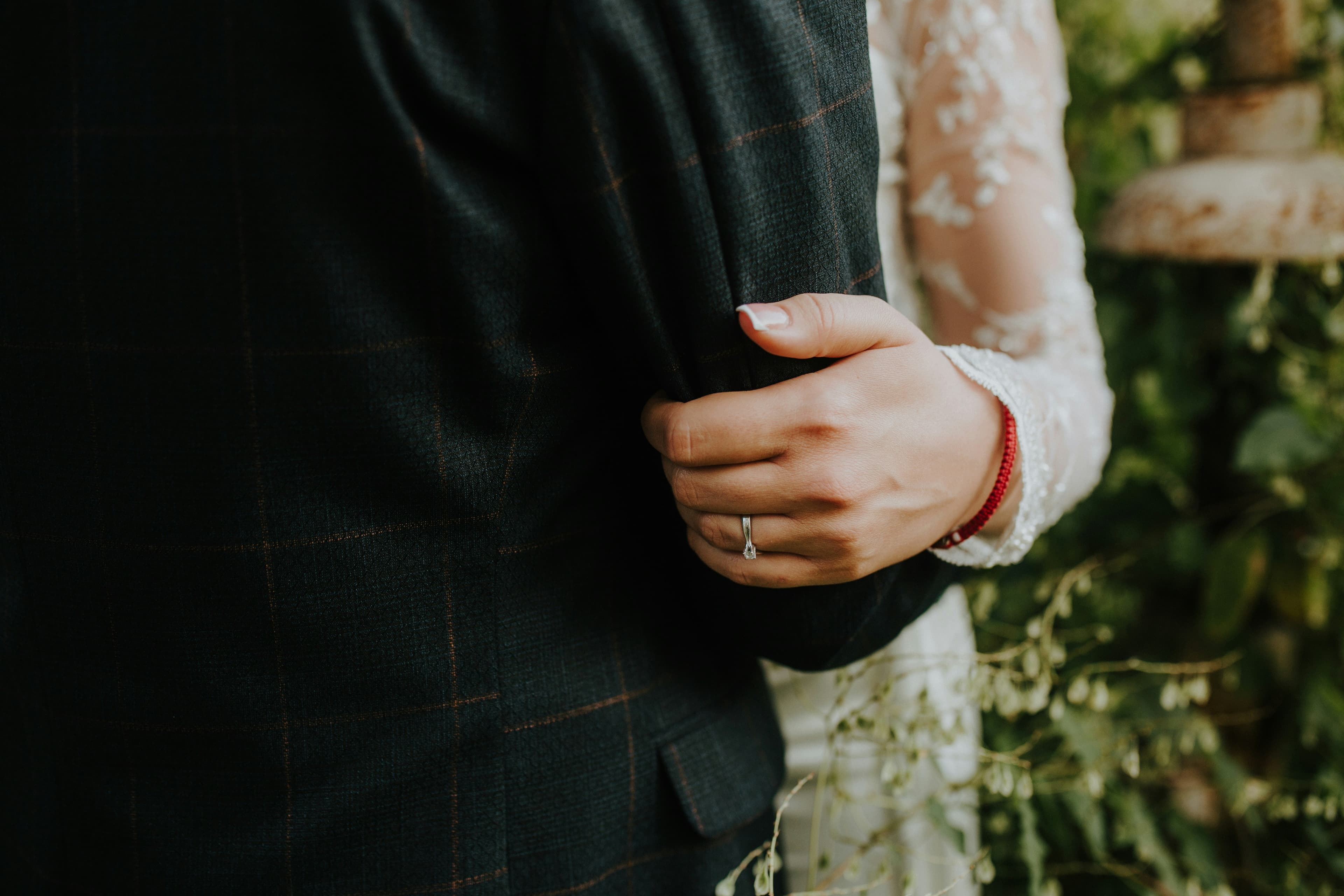 Couple holding hands while reviewing marriage planning documents
